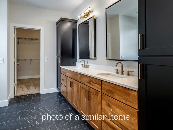a spacious bathroom with a double vanity sink and a mirror