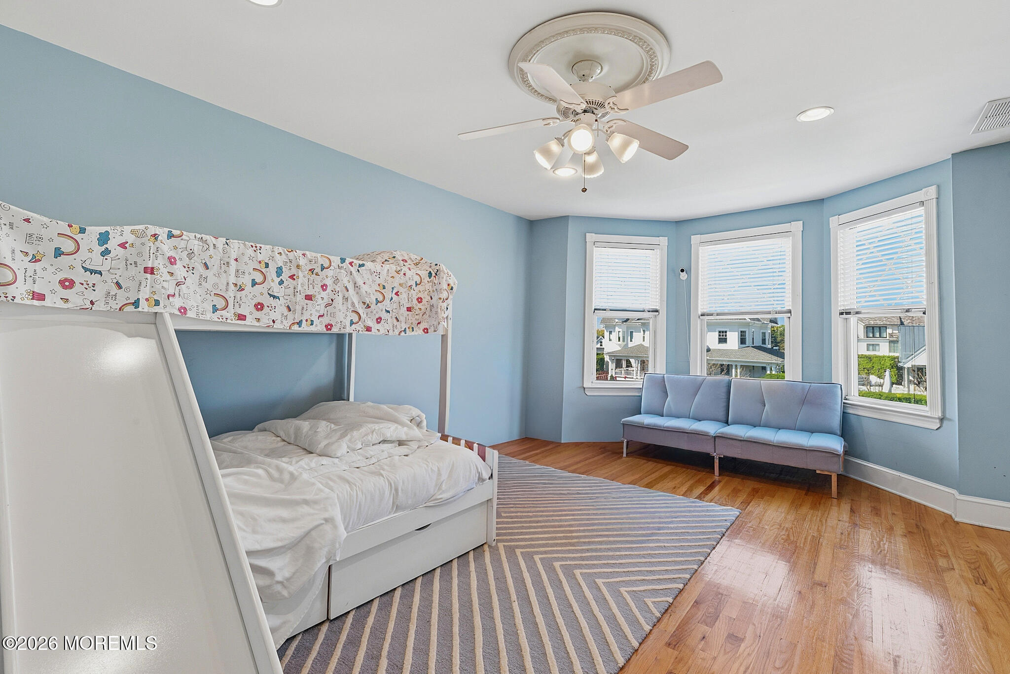 48 Neptune Avenue Deal, NJ 07723 - Photo 15 of 32 a bedroom with a large bed and a chandelier