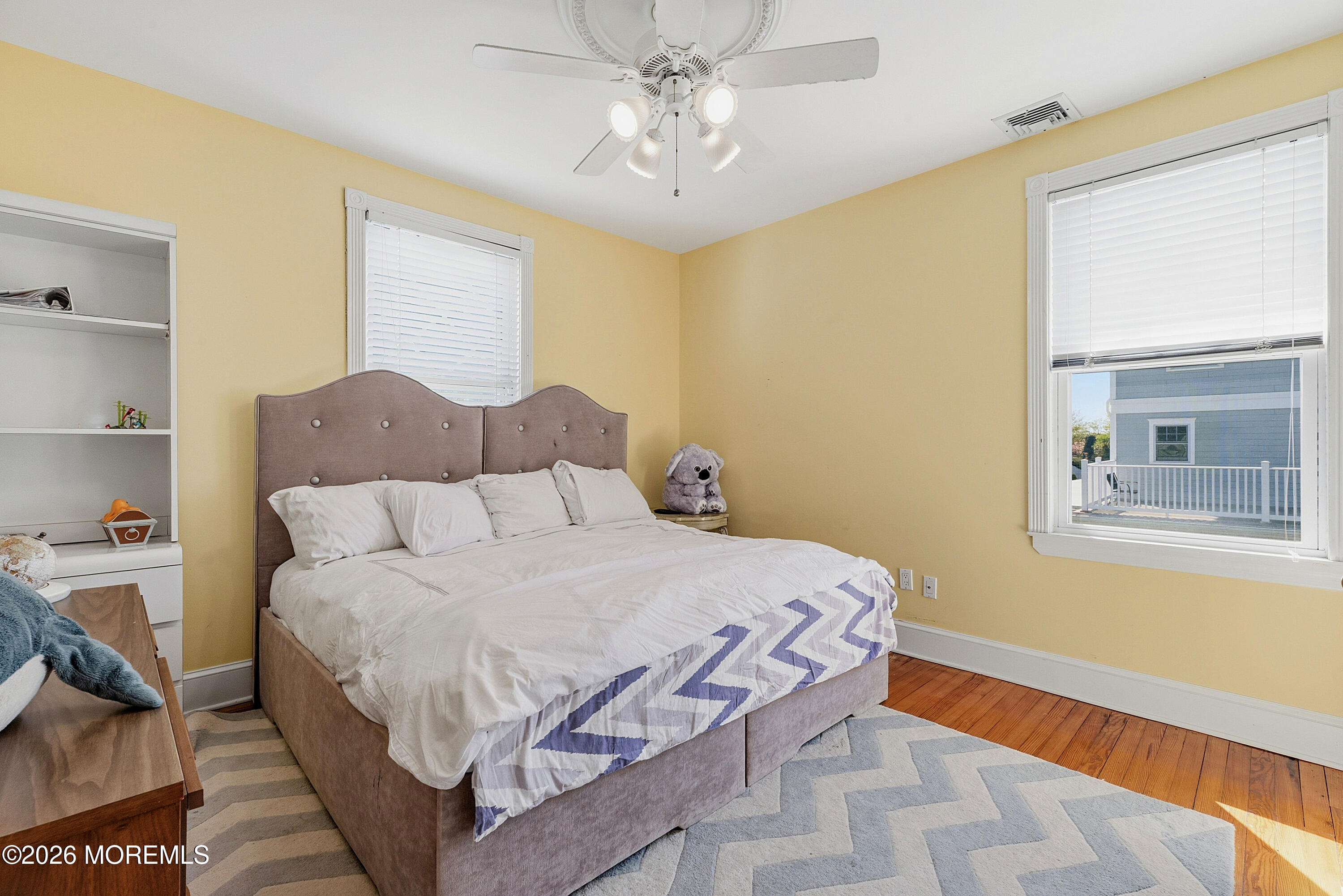 48 Neptune Avenue Deal, NJ 07723 - Photo 18 of 32 a bedroom with a bed and a chandelier