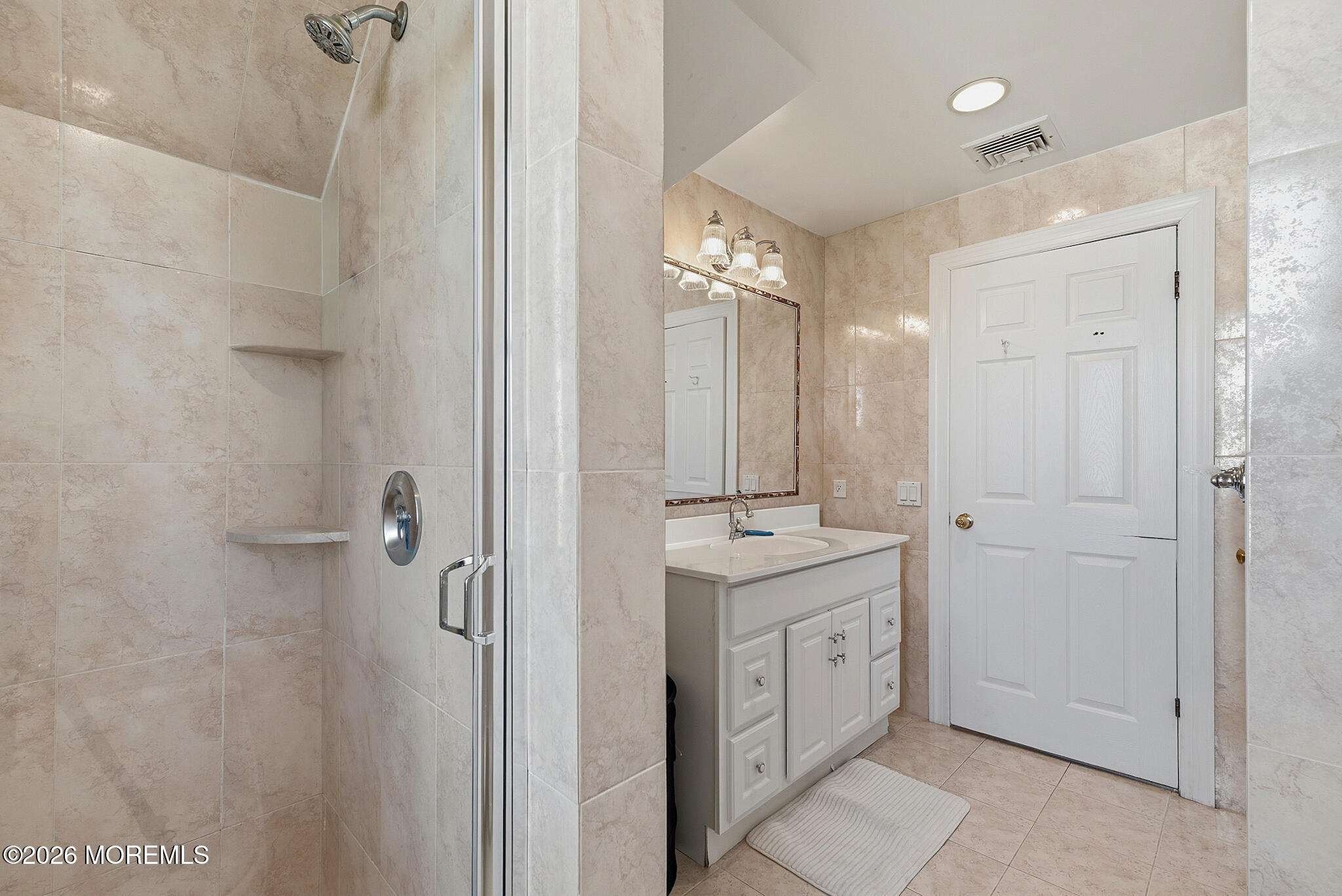 48 Neptune Avenue Deal, NJ 07723 - Photo 19 of 32 a spacious bathroom with a granite countertop sink a mirror and shower
