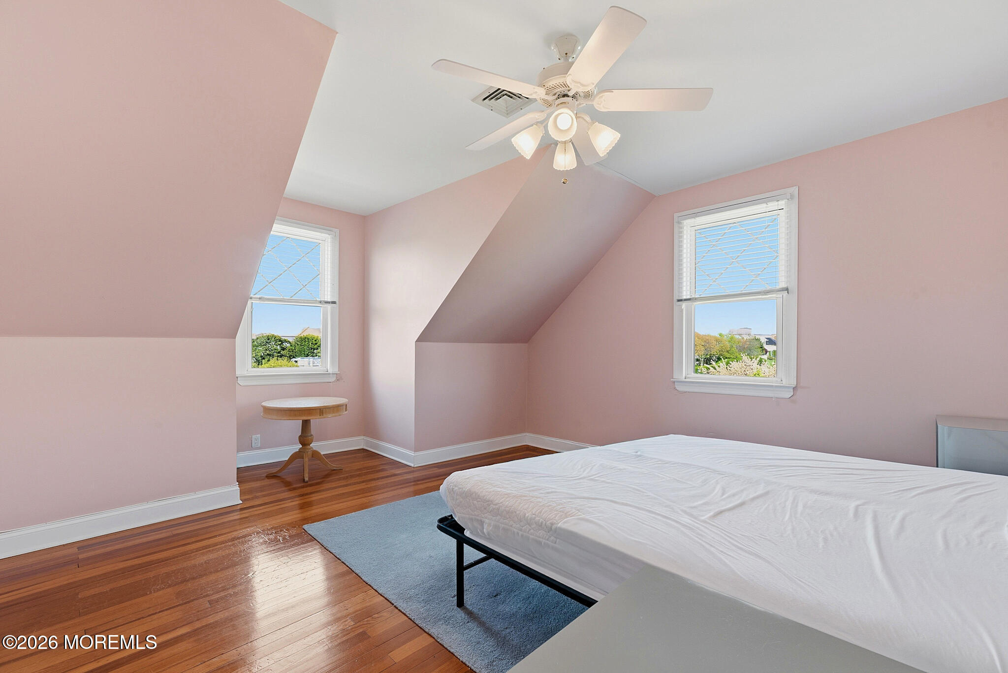 48 Neptune Avenue Deal, NJ 07723 - Photo 21 of 32 a bedroom with a bed window and a chandelier