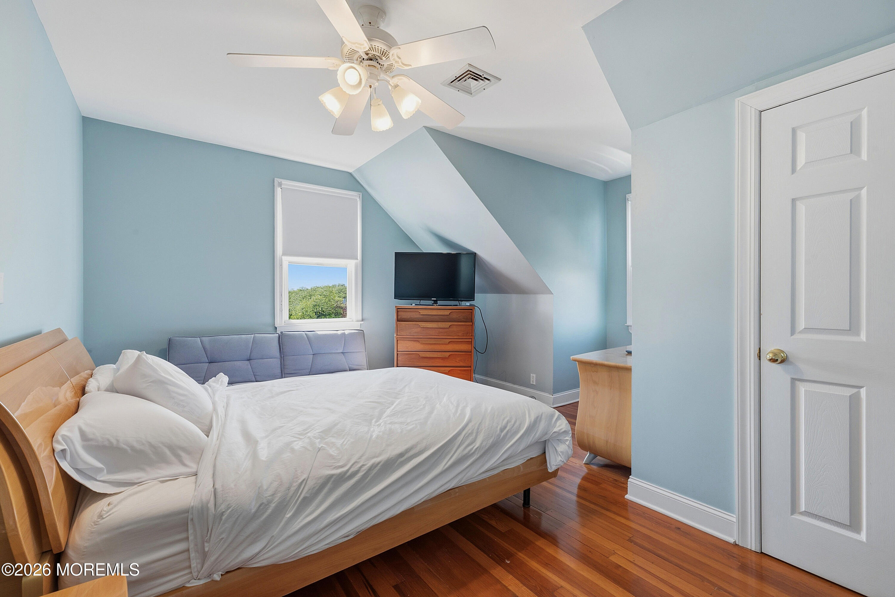 48 Neptune Avenue Deal, NJ 07723 - Photo 23 of 32 a bedroom with a bed ceiling fan and a window