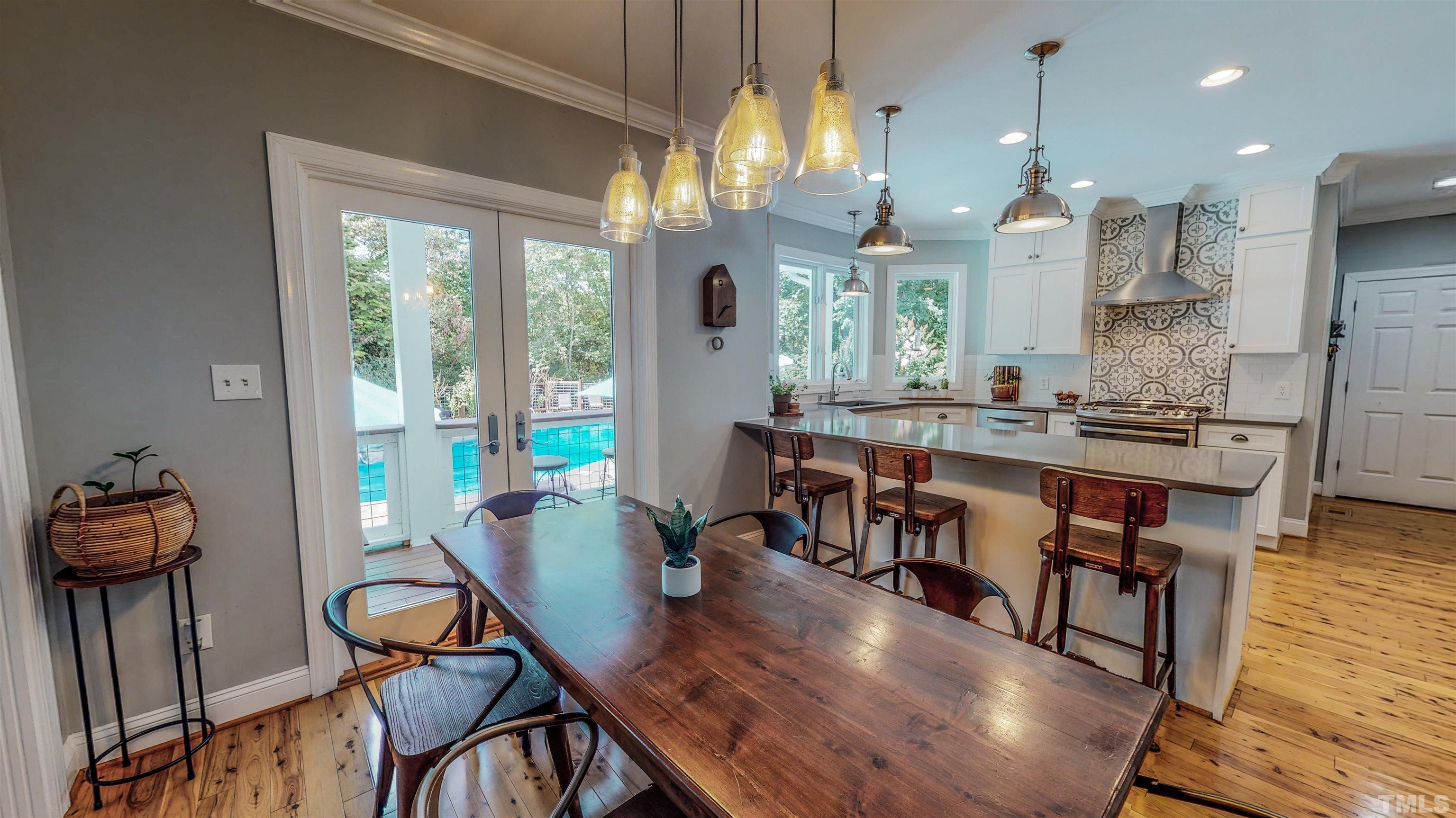 303 Bowen Road Rougemont, NC 27572 - Photo 27 of 85 a view of a dining room with furniture a chandelier and wooden floor
