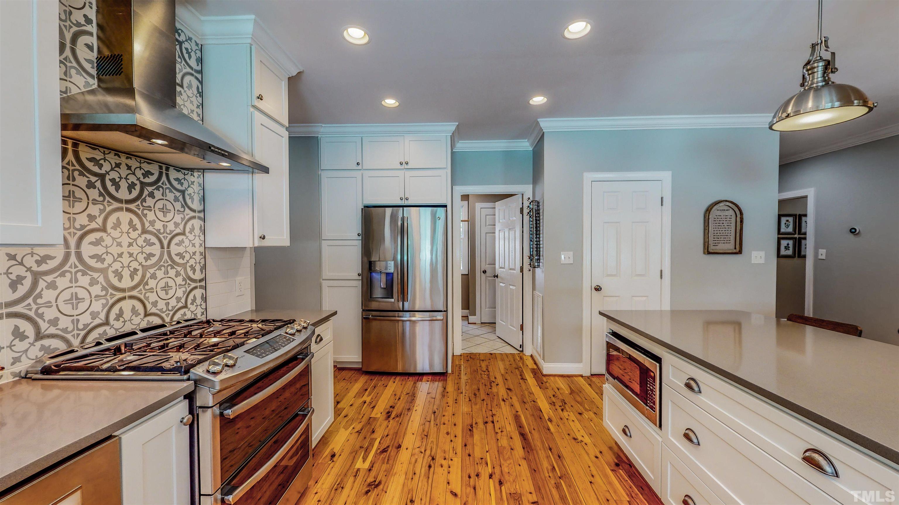 303 Bowen Road Rougemont, NC 27572 - Photo 29 of 85 a kitchen with stainless steel appliances granite countertop a stove and a refrigerator