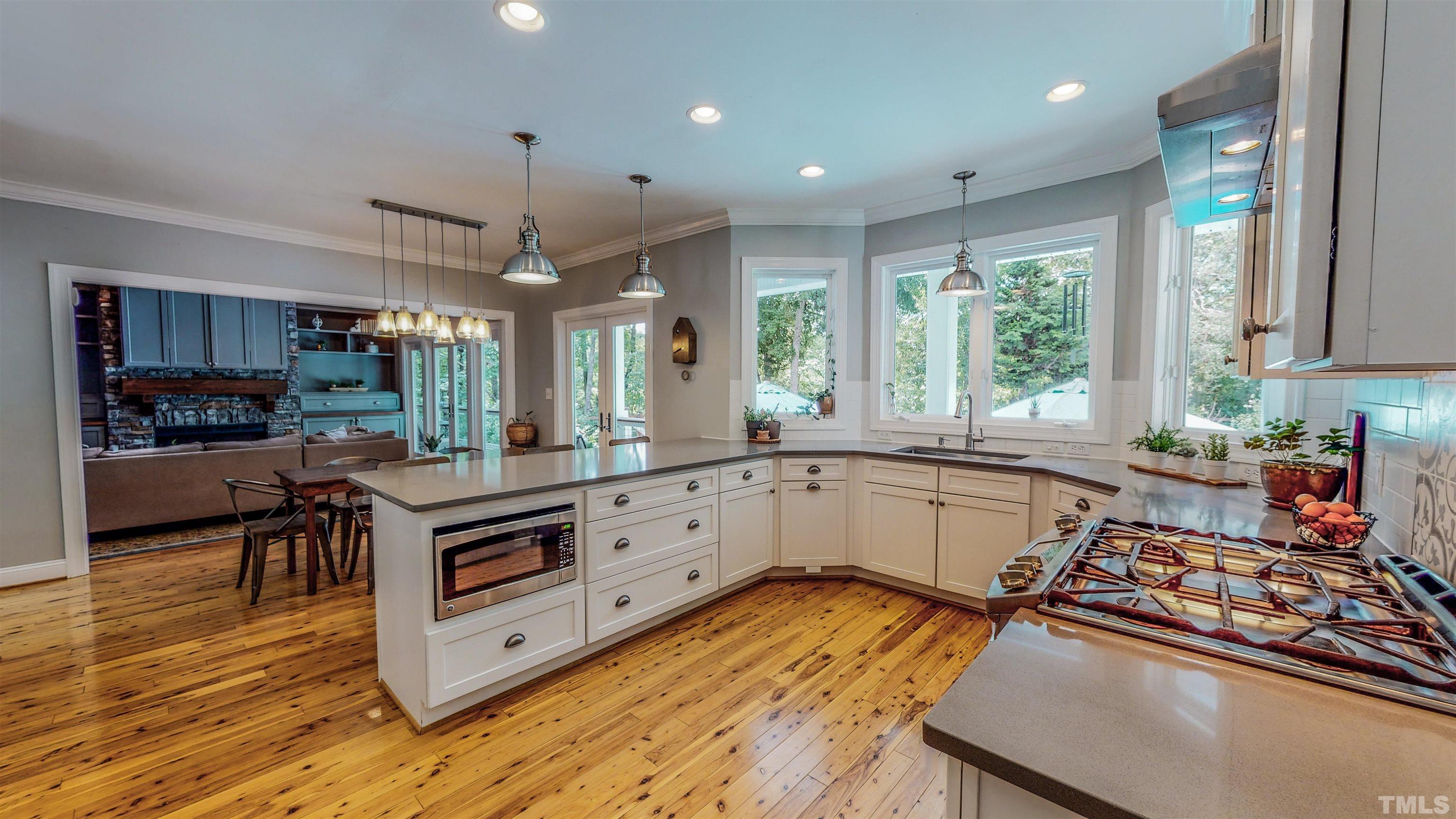 303 Bowen Road Rougemont, NC 27572 - Photo 31 of 85 a kitchen with stainless steel appliances granite countertop a stove and a wooden floors
