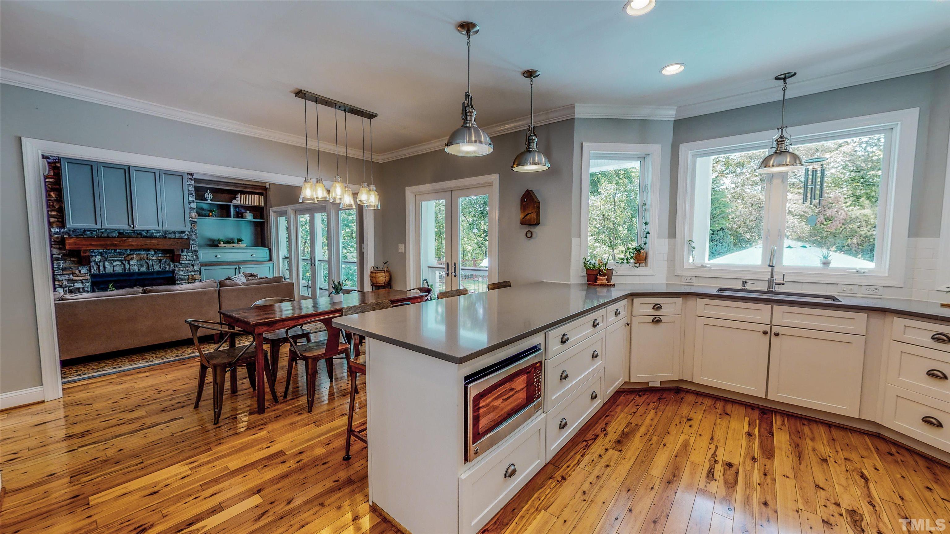 303 Bowen Road Rougemont, NC 27572 - Photo 71 of 85 a kitchen with stainless steel appliances granite countertop a stove and a wooden floors