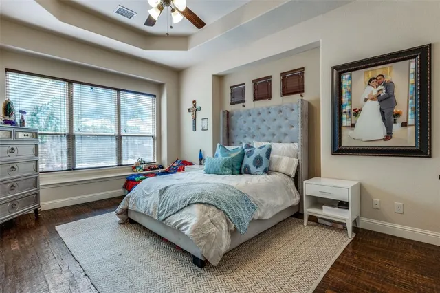 a spacious bedroom with a bed and a large window