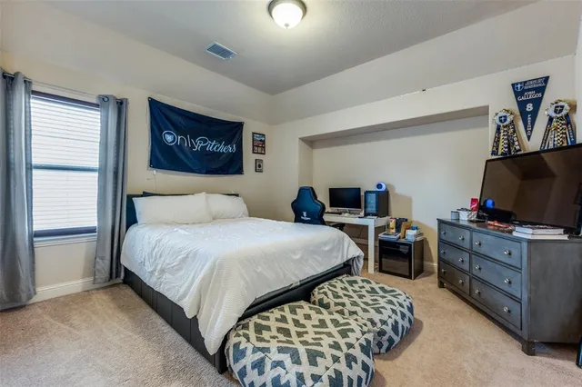 a bedroom with a bed and a flat screen tv