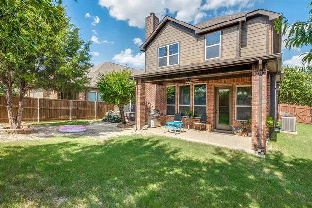 a view of a house with a yard and sitting area