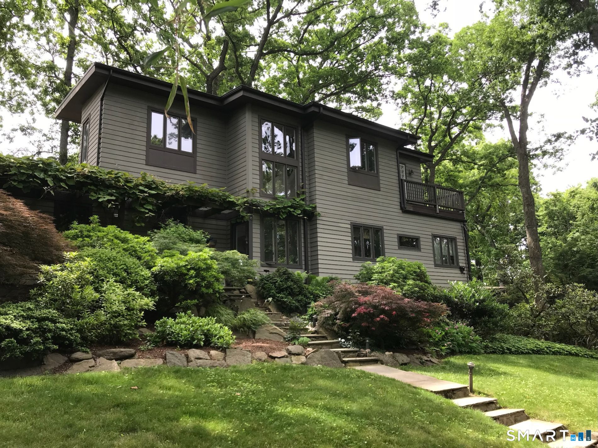31 Splitrock Road Norwalk, CT 06854 - Photo 2 of 38 a front view of a house with a yard and garage