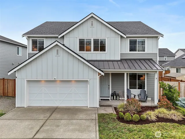 a front view of a house with yard and porch