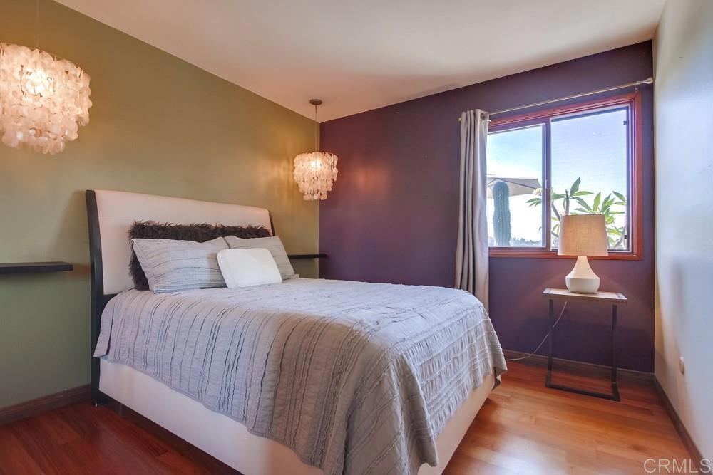 428 Compass Road Oceanside, CA 92054 - Photo 15 of 21 a bedroom with a bed and dresser with wooden floor