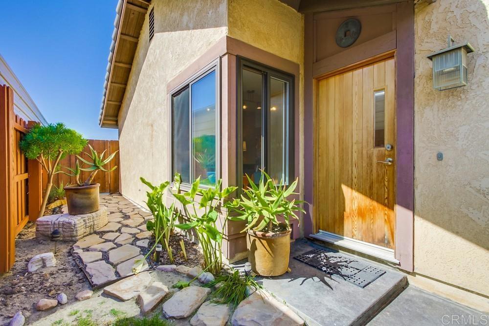 428 Compass Road Oceanside, CA 92054 - Photo 2 of 21 a view of a potted plants on the front of a glass door
