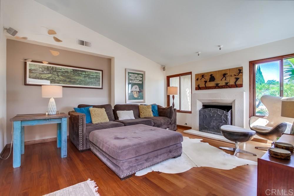 428 Compass Road Oceanside, CA 92054 - Photo 3 of 21 a bedroom with a bed a rug and a fireplace