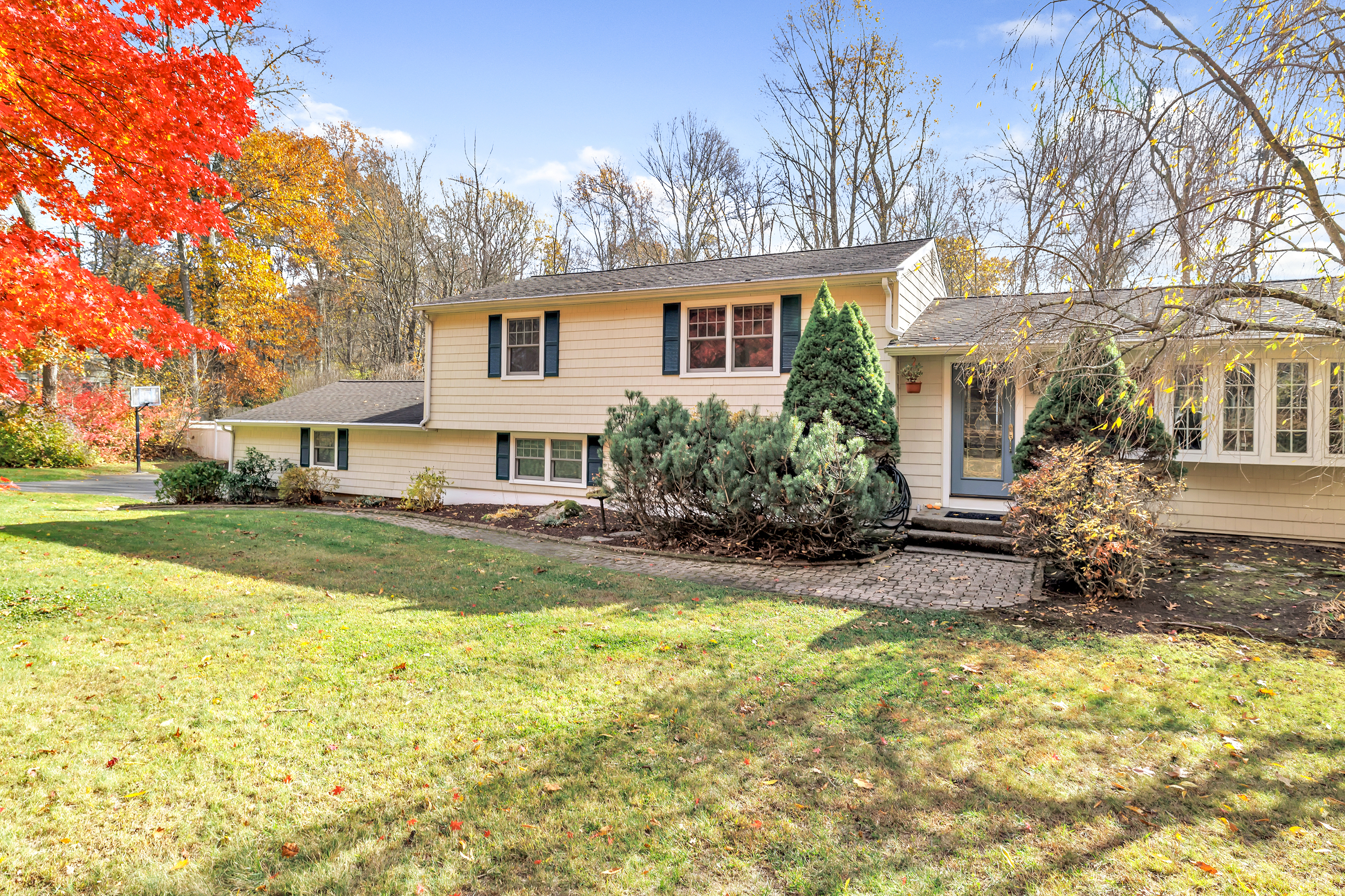 a front view of house with yard and trees around