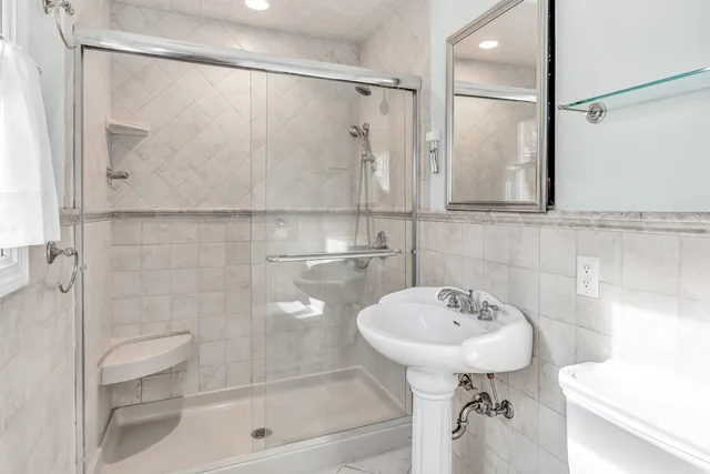 a bathroom with a sink toilet and shower