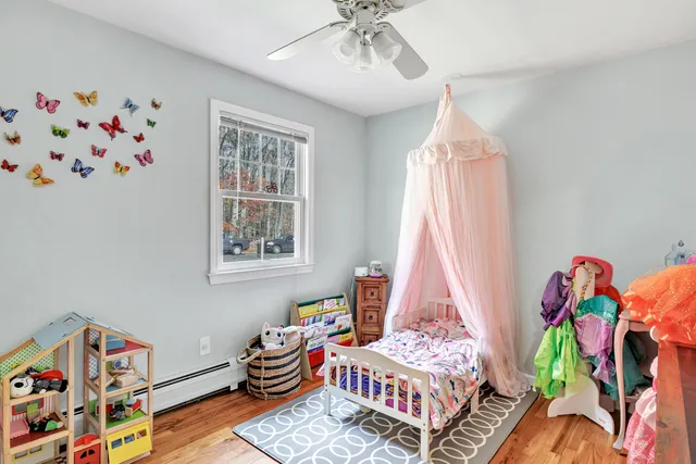 a living room with a baby crib furniture and a window