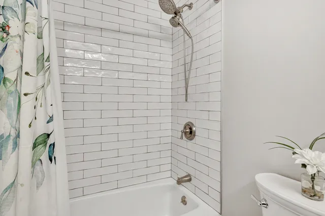 a bathroom with a bathtub and shower