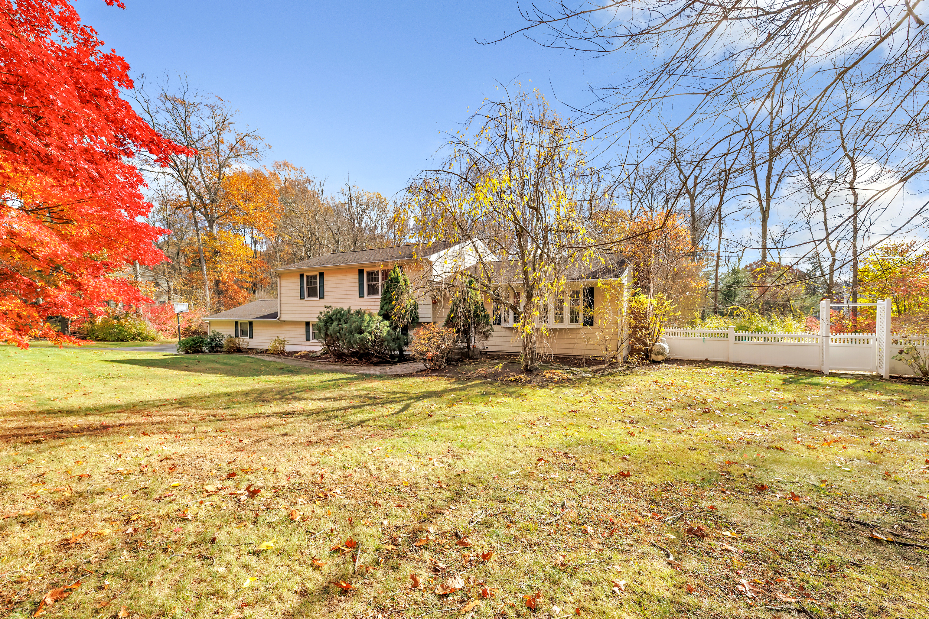 91 Harvester Road Monroe, CT 06468 - Photo 33 of 35 a front view of a house with a yard and trees