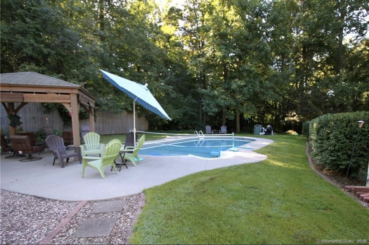 91 Harvester Road Monroe, CT 06468 - Photo 35 of 35 a view of backyard with table and chairs and potted plants
