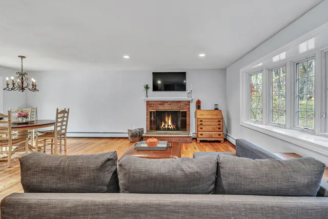 a living room with furniture fireplace and flat screen tv