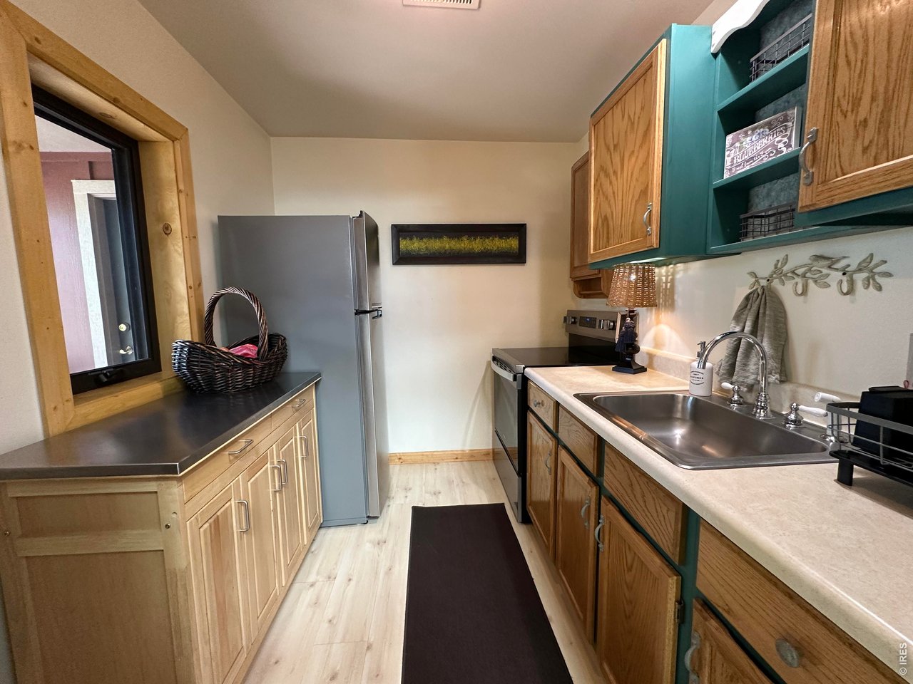 123 Mohawk Road Lyons, CO 80540 - Photo 27 of 35 a kitchen with granite countertop a sink stove and cabinets