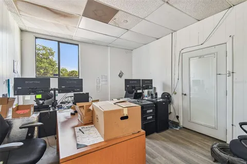 a view of a workspace with furniture and a flat screen tv