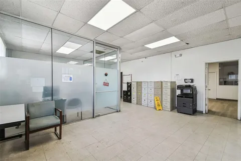 an aerial view of residential houses with outdoor space and street view