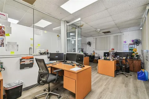 an aerial view of a city with lots of residential buildings ocean and mountain view in back