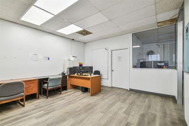 an aerial view of a house with a yard and lake view