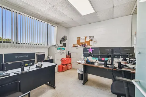 an aerial view of a house with a yard and lake view