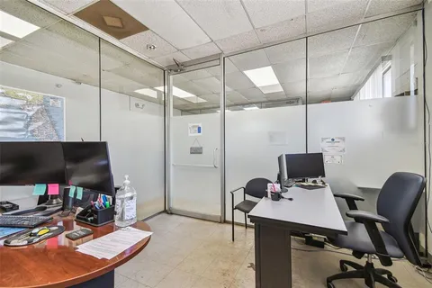 an aerial view of a house with a yard and lake view