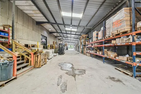 a view of a patio with table and chairs and potted plants