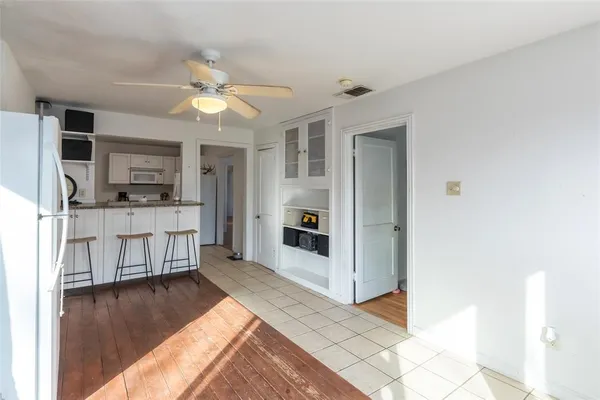 a view of a kitchen with microwave and cabinets