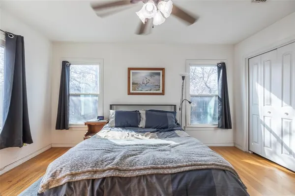 a bedroom with a large bed and a chandelier