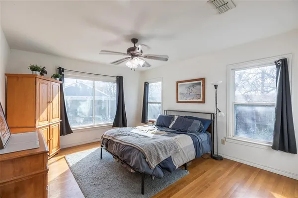 a bedroom with a large bed and a window
