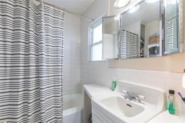 a bathroom with a sink a mirror and a window