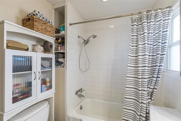 a bathroom with a bathtub and shower