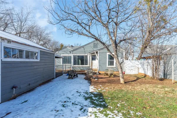 a view of a house with a yard covered in snow