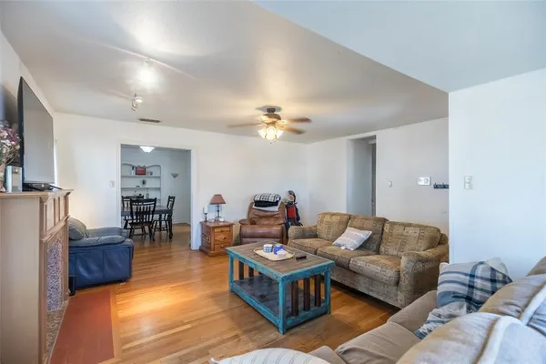a living room with furniture and wooden floor