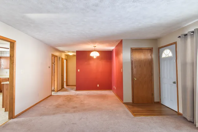 a view of a house with a yard and sitting area
