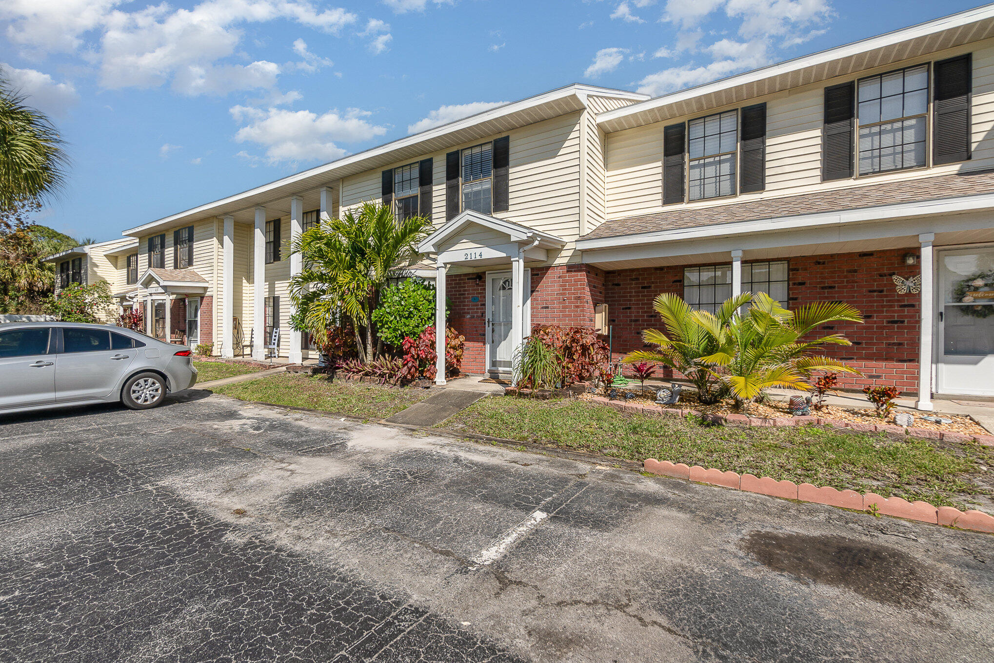 2114 Manor Drive Northeast Palm Bay, FL 32905 - Photo 19 of 24 a front view of a house with garden
