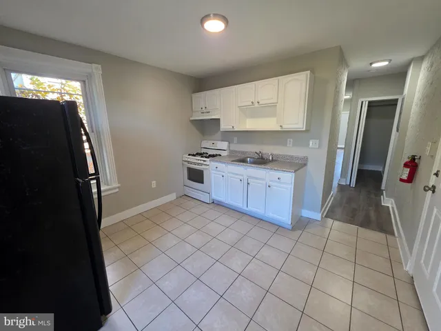 a kitchen with stainless steel appliances a sink stove and refrigerator