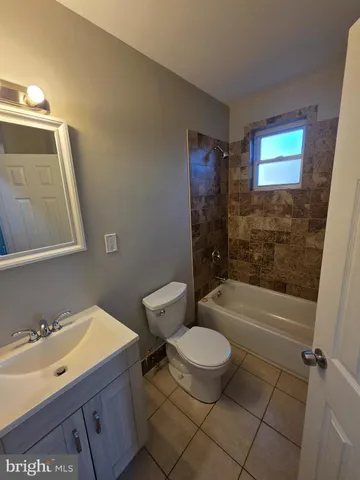 a bathroom with a sink a toilet a bathtub and shower