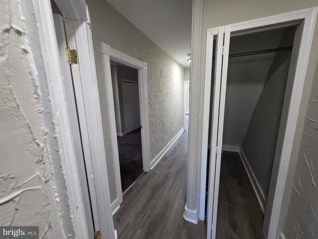 a view of hallway with wooden floor