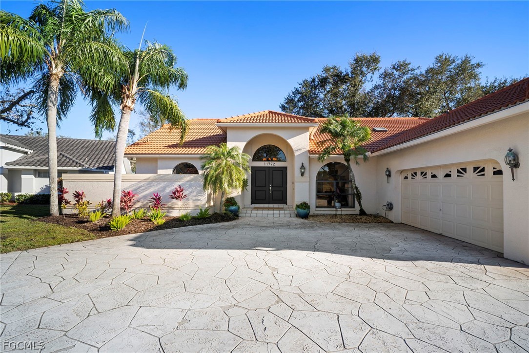 11772 Mahogany Run Fort Myers, FL 33913 - Photo 1 of 50 a front view of a house with a yard and a garage