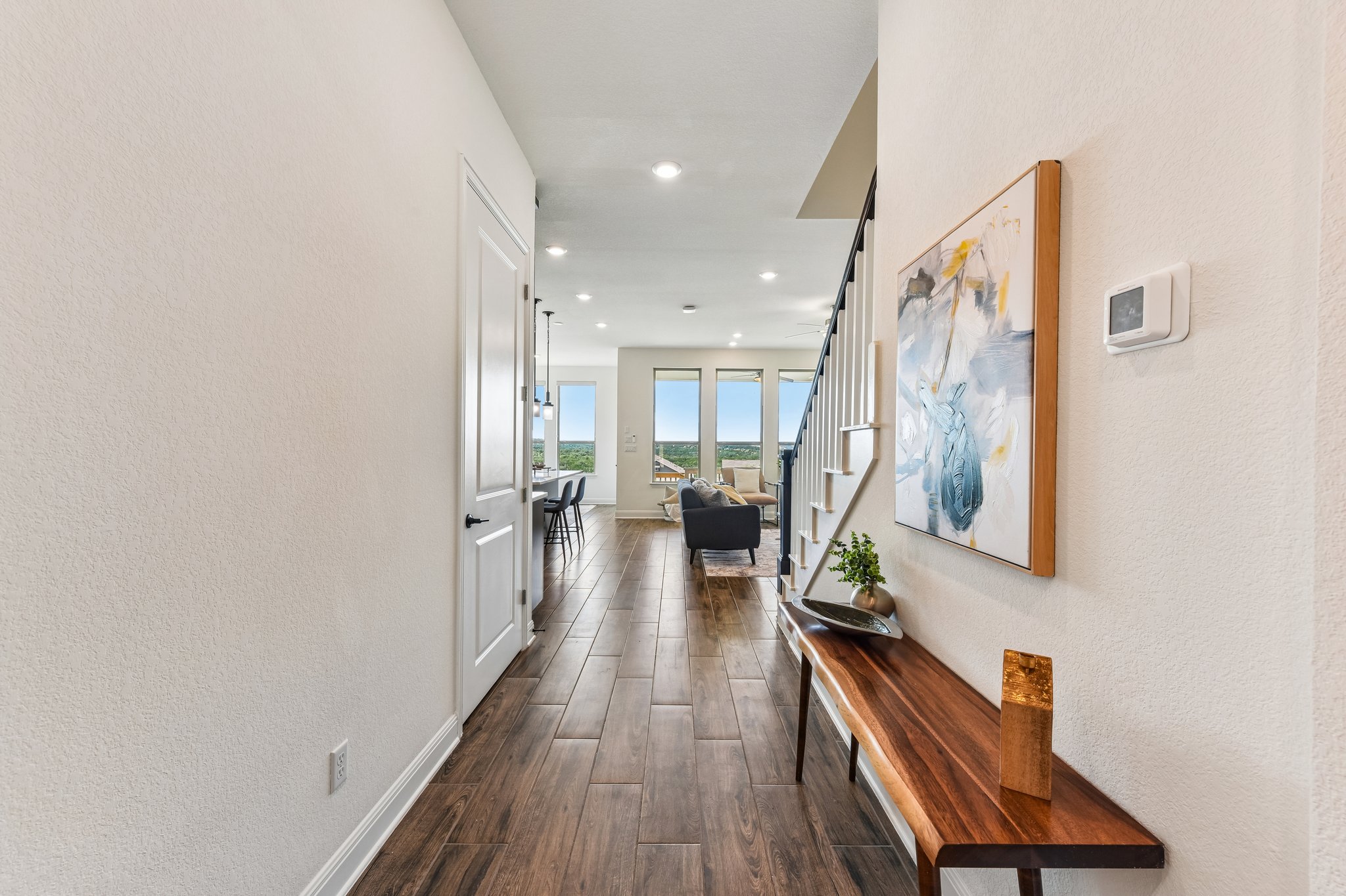 19113 Freeman Circle Austin, TX 78738 - Photo 17 of 37 Long, richly-toned wood flooring guides you through this bright entrance foyer toward a spacious living area.