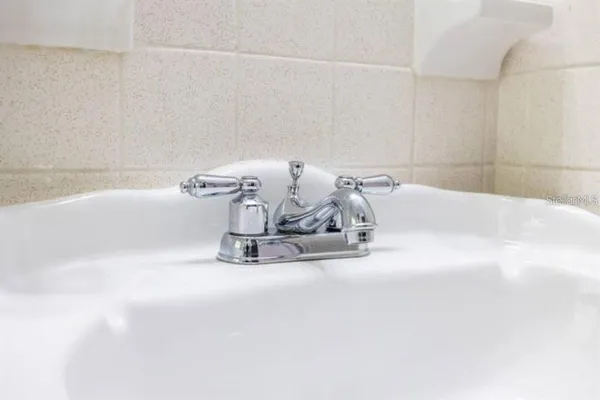 a bath tub sitting next to a white sink