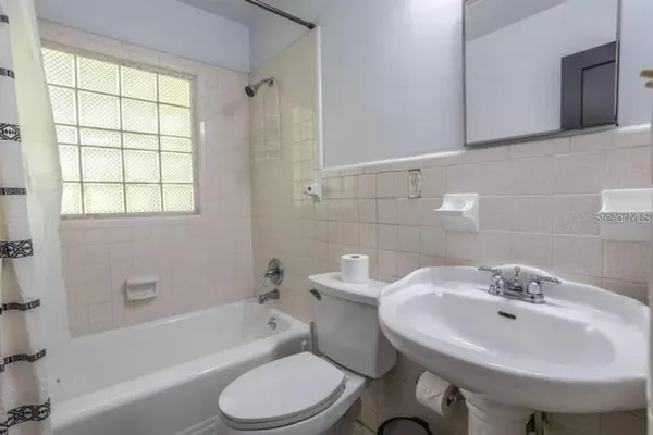 a bathroom with a sink toilet and bathtub