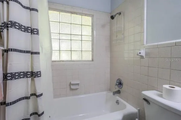 a bath room with a bath tub and a shower